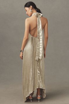 Embracing a flair for drama & grandeur, the Opera plays carefully with modern elegance. Featuring a high neckline, tie back halter and asymmetrical silhouette, this stunning billowing pleat full-length dress will transform you for an evening to remember. | Opera Halter Cutout Maxi Gown by L'IDÉE in Gold, Women's, Size: 8, Polyester/Tin at Anthropologie Gown Gold, Halter Gown, Bridal Shower Dress, Exclusive Dress, Full Length Dress, Dress Home, Maxi Gowns, Denim Design, Gold Dress