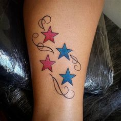 a woman's leg with three stars and swirls on the bottom part of it