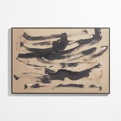 an abstract painting hangs on the wall in front of a white wall with black and tan paint