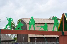 the silhouettes of people are on top of a swing set