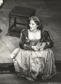 an old photo of a woman sitting on the floor