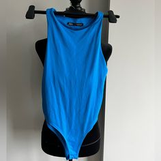 a blue bodysuit hanging on a black mannequin