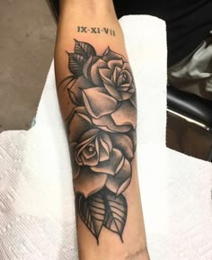 a black and white rose tattoo on the arm