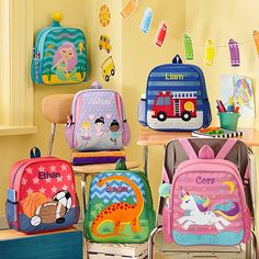 several children's backpacks sitting on top of chairs