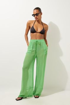 Feel Summer Ready In A Pair Of Beach Trousers, With Lightweight Fabric Perfect For Sunny Days, And A Relaxed Fit Ideal For Laidback Days By The Pool. This Piece Can Easily Be Styled With A Crop Top Or A Bikini And Strappy Sandals For A Holiday Outfit That Goes Seamlessly From Day To Night. Wide Leg Woven Beach Trousers Statement, Ultra Wide Leg Fit Comfortable High Waistline Statement Sheer Fabric Drawstring Waistband Pocket Features Green Beachwear Bottoms For Vacation, Green Summer Pants With Elastic Waistband, Green Wide Leg Pants For Beach In Spring, Spring Beach Wide Leg Full Length Pants, Summer Vacation Wide Leg Full Length Pants, Spring Green Wide Leg Pants For Beach, Spring Beach Wide-leg Full-length Pants, Chic Full Length Wide Leg Beach Pants, Wide Leg Full-length Pants With Elastic Waistband For Beach