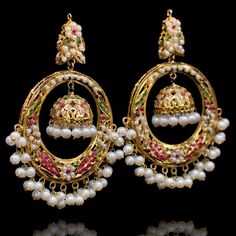 Simple, stylish and encompassing the essence of traditional charm! This pair is adorned with ruby and emerald stones in addition to pearl moti reflecting a delicate touch to its beautiful composition of chand-bali and jhumki design. Approximate earrings length is 3.25". Gold-plated on high-quality brass as base metal. Made by order. Kindly allow 5-7 weeks for the delivery of this item. For custom or urgent requests, please contact support@alacouture.com *Please Note: We use faux stones and beads Chand Bali, Beautiful Composition, Faux Stone, Emerald Stone, Large Earrings, Small Earrings, Cz Stone, Base Metal, Bali