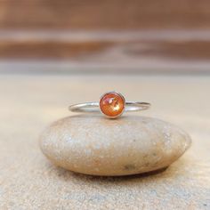 Handcrafted sterling silver stacking ring featuring natural orange Sunstone gemstone, perfect for everyday wear.  The ring sizes correspond to US ring measurement, in the last photo you will find an international ring size chart. * MATERIALS & SIZE: Natural stone: Sunstone Stone size: 5mm Metal: Sterling Silver Sterling Silver Orange Gemstone Rings, Sterling Silver Gemstone Ring In Orange, Orange Gemstone Ring In Sterling Silver, Sterling Silver Rings With Orange Gemstone, Orange Sterling Silver Promise Ring Jewelry, Orange Birthstone Jewelry For Promise Ring, Minimalist Amber Ring Jewelry, Sterling Silver Amber Birthstone Rings, Orange Gemstone Promise Ring