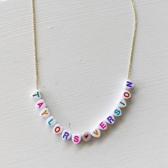 Always choose Taylor's version! You can showcase your favorite song or album with this personalized necklace! Cute little letter beads strung on either a dainty 24k gold or silver chain - perfect for any mood or outfit! Our resident Swiftie has assembled some options that perfectly depict each era for you to use as examples. {Thanks Ali!} *Personalize this necklace with your favorite song or album *This necklace measures 18" Trendy Personalized Charm Necklaces For Birthday, Trendy Customizable Charm Necklaces For Gifts, Trendy Customizable Charm Necklaces As Gift, Trendy Personalized Charm Necklace For Birthday, Trendy Personalized Name Necklace For Everyday, Trendy Custom Name Jewelry For Everyday, Trendy Custom Name Jewelry For Everyday Wear, Trendy Initial Necklace With Letter Beads For Gifts, Trendy Initial Necklace With Letter Beads As Gift