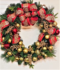 a christmas wreath with red and gold ornaments