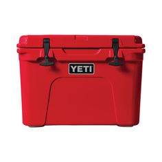 the yeti cooler is red with black handles and latches on it's sides