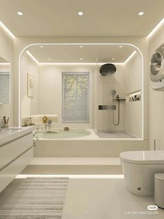 a white bathroom with a tub, sink and toilet in the center is illuminated by recessed lights