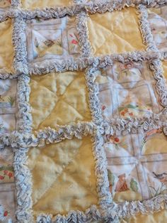 an old fashioned quilt has been made into a baby blanket with ruffle trims