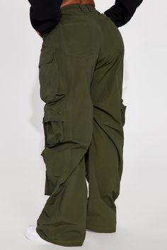 Available In Olive. Cargo Pant High Rise Button & Zip Closure Wide Leg Oversized Fit Non Stretch Distressed Wash Effect Windbreaker Fabric 65% Cotton 35% Nylon Imported | Talk It Up Oversized Distressed Washed Cargo Pant in Olive Green size XS by Fashion Nova Green Cargo Style Wide-leg Parachute Pants, High Waist Green Parachute Pants With Multiple Pockets, Green Baggy Cargo Jeans With Hip Pockets, Green Baggy Full-length Cargo Jeans, Military Style Wide Leg Bottoms For Outdoor, Military Cargo Bottoms Full Length, Full-length Military Cargo Bottoms, Full Length Military Cargo Bottoms, Military Cargo Style Full Length Bottoms