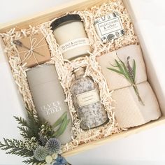 an open gift box containing candles, soaps and other personal care items in it