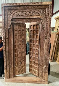 an intricately carved wooden door is being displayed