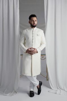 This White Long Sherwani is a stunning choice for your special occasion. Made from printed off-white khaadi silk, it features a silk kurta and cotton pajama for a comfortable fit. Complete your look with the elegant organza Rajastjhani kula (turban) and exude an air of style and sophistication. Silk Kurta, Cotton Pyjamas, Sherwani, Your Special, Wedding Men, Winter Women, Special Occasion, Comfort Fit, Pajamas