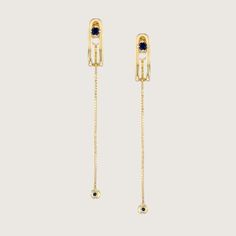 An impressive and special earring with a design element in the form of a vertical clasp inspired by the world of tailoring that characterizes the TAILORED collection. The top of the element is studded with a 3 mm Sapphire that gives the earring a powerful look without detracting from its delicacy. A delicate chain with a Sapphire studded gold ball at the end, threaded from the bottom of the earring, adds an elegant sway to this special piece. The earring is inspired by the buttons and cuffs that make up the female suit and is part of the TAILORED collection The earrings are sold as singles All features can be customized! Please contact us if you wish to make changes, we love making custom designs. All of our jewelry is carefully handmade in our atelier. *HC diamond are all conflict-free di Luxury Drop Earrings With 17 Jewels, Luxury Yellow Gold Dangle Clip-on Earrings, Timeless Evening Earrings With 17 Jewels, Fine Jewelry Linear Pierced Earrings For Evening, Fine Jewelry Linear Earrings For Evening, Luxury Clip-on Yellow Gold Earrings, Luxury White Gold Clip-on Jewelry, Luxury 14k Gold Clip-on Jewelry, Luxury 14k White Gold Linear Earrings