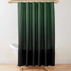 a green shower curtain with gold hardware on the top and bottom, in front of a white bathtub