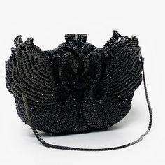 Black Swans formal evening handbag is a magnificent masterpiece perfectly covered in onyx black crystals. This stunning bag is complete with black hardware and removable black snap hook chain. This marvelous soulmate art bag can be carry in hand with or without chain. Glamorous and functional, this clutch can hold securely your keys, cards, cash and other small necessities.   Details: Measurement: 7.5in length x 5in high x 2in width Color: black crystals Lining: sliver vegan leather Closure: mag Luxury Handheld Evening Shoulder Bag, Luxury Handheld Shoulder Bag For Evening, Black Rhinestone Shoulder Bag For Events, Black Luxury Evening Bag With Top Handle, Black Luxury Top Handle Evening Bag, Luxury Black Embellished Clutch, Luxury Black Handheld Evening Bag, Black Handheld Evening Bag With Rhinestones, Black Rectangular Evening Bag With Rhinestones