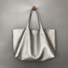 Overview: Design: Fashion Womens Silver Leather Oversize Tote Bag Black Shoulder Tote Bag Handbag Tote For WomenIn Stock: Made to order (2-3 days)Include: Tote + A detachable Side InnerCustom: NoColor: Silver, BlackLeather: CowhideMeasures: Horizontal Style S: 46cm/Bottom 34cm x 30cm x 14cmHorizontal Style L: 50cm/Bottom 37cm x 33cm x 16cm Vertical Style S: 41cm/Bottom 33cm x 35cm x 11cm Vertical Style L: 47cm/Bottom 37cm x 40cm x 11cmWeight: 0.75 kgSlots: 1 slotAccessories(option): NoStyle: Fas Handheld Shoulder Bag With Silver-tone Hardware For Travel, Travel Handheld Shoulder Bag With Silver-tone Hardware, Everyday Tote Bag With Silver-tone Hardware, Top Handle Shoulder Bag With Silver-tone Hardware For Shopping, Bags With Silver-tone Hardware For Daily Use, Shopping Shoulder Bag With Top Handle And Silver-tone Hardware, Daily Use Satchel Tote With Silver-tone Hardware, Daily Use Satchel With Silver-tone Hardware And Tote Shape, Daily Use Tote Satchel With Silver-tone Hardware