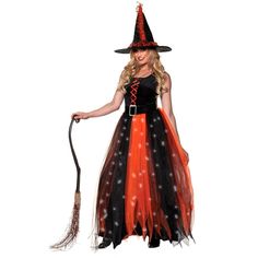 a woman in a witch costume holding a broom