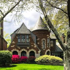 a large brick house with a turret roof