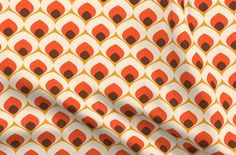 an orange and white wallpaper with black circles on it's surface, as well as the shadow of a person standing in front