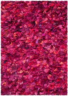 a pink rug with lots of red leaves on it