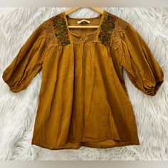 Custom Designed In Mexico, With Natural Dyes On 100% Linen Fabric. Hand Embroidered Designs. Dry Clean Or Hand Wash On Gentle Cycle With Like Colors. Pit To Pit: 19 Inches Length: 25 Inches Width At Bottom: 23.5 Inches Casual Cotton Peasant Top With Embroidered Sleeves, Fall Cotton Blouse With Floral Embroidery, Bohemian Half Sleeve Tops For Fall, Yellow Embroidered Tops For Fall, Brown Floral Embroidered Long Sleeve Top, Bohemian Tops With 3/4 Sleeve And Floral Embroidery, Brown Embroidered Long Sleeve Blouse, Brown Long Sleeve Top With Floral Embroidery, Spring Blouse With Floral Embroidery And 3/4 Sleeves