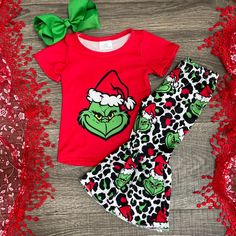 Adorable 2pc Outfit Includes Red Short Sleeve Top With Grinch Design And Matching Leopard Print And Grinch Design Bell Style Pants. Red Festive Sets For Winter, Festive Red Sets For Winter, Festive Red Holiday Sets, Holiday Festive Red Set, Festive Red Holiday Set, Fitted Red Set For Holidays, Cute Cotton Holiday Sets, Cute Cotton Sets For Holidays, Casual Fitted Sets For Holiday