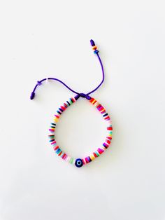 "Heishi Beads Bracelet Strung on a Vibrant Purple String and Accented with the Iconic Blue Evil Eye that has become our brand DNA. Bracelet arrives in a beautiful package with a sweet, meaningful blessing for you and loved ones that reads, \"𝙈𝙖𝙮 𝙮𝙤𝙪 𝙗𝙚 𝙋𝙧𝙤𝙩𝙚𝙘𝙩𝙚𝙙, 𝙃𝙖𝙥𝙥𝙮, 𝙃𝙚𝙖𝙡𝙩𝙝𝙮 𝙖𝙣𝙙 𝙒𝙚𝙖𝙡𝙩𝙝𝙮\". 𝗛𝗲𝗶𝘀𝗵𝗶 𝗣𝗮𝗿𝘁𝘆 https://etsy.me/3p7X8DG 𝗠𝗼𝗿𝗲 𝗘𝘁𝘀𝘆 𝗮𝘄𝗲𝘀𝗼𝗺𝗲𝗻𝗲𝘀𝘀 https://etsy.me/3jMTB8z * Convenient adjustable sliding knot for an easy comfo Trendy Multicolor Evil Eye Bracelet For Beach, Playful Adjustable Blue Friendship Bracelets, Playful Blue Friendship Bracelets With Colorful Beads, Casual Multicolor Evil Eye Bracelet For Beach, Trendy Adjustable Multicolor Evil Eye Bracelet, Adjustable Multicolor Evil Eye Bracelet For Beach, Adjustable Purple Friendship Bracelets For Beach, Trendy Multicolor Evil Eye Bracelet For Friendship, Purple Beaded Friendship Bracelet With Sliding Knot