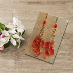 "Elegantly designed glass floral fringe earrings.   These beautiful earrings will go with almost anything in your closet, or a friend's.   Look no further, you have just found the perfect girlfriend, sister, or mother's gift.  There has never been a better time to showcase your uniqueness. FIT AND FINISH FOR YOUR PRODUCT Color: Red and Gold Size: 3\" fringe dangle design Material: Glass Beads on Gold Chain   WHAT'S IN THE BOX: 1 pair of earrings. Any other items shown in picture are for staging Red Chandelier Earrings As Gift, Red Nickel-free Chandelier Earrings As Gift, Handmade Red Chandelier Earrings Gift, Dangle Crystal Earrings As Gift, Glass Crystal Dangle Earrings As Gift, Glass Drop Crystal Earrings For Gift, Handmade Red Glass Earrings, Perfect Girlfriend, The Perfect Girlfriend