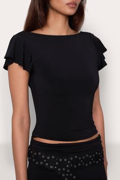 Our Soffiano Top has a fitted matte jersey bodice that sits just above the hips with a slightly draped back, and a boat neck with ruffled cap sleeves. Composition: 92% Polyester, 8% Spandex Dani is wearing a size S and is 5'10" with a 32" bust, 35" hips, and 25" waist Fitted Scoop Neck Top With Ruffles, Stretch Elastane Tops For Evening, Chic Fitted Tops With Cap Sleeve, Chic Fitted Cap Sleeve Tops, Solid Ruffled Tops For Evening, Fitted Ruffle Tops With Flutter Sleeves, Fitted Tops With Ruffle Sleeves For Night Out, Fitted Solid Boat Neck Tops, Elegant Fitted Tops With Cap Sleeves