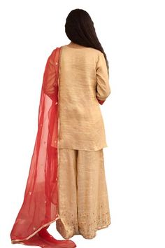 Gold kurta with placement hand embroidery. Paired with a sharara with hand embroidered hem and red dupatta with embroidered buttis. - Aza Fashions Festive Tussar Silk Sharara, Tussar Silk Palazzo Set For Wedding Navratri, Fitted Slub Silk Sharara For Festivals, Ceremonial Cotton Silk Sets With Traditional Drape, Ceremonial Cotton Silk Festive Sets, Ceremonial Festive Cotton Silk Sets, Ceremonial Silk Traditional Wear With Gota Work, Bollywood Style Cotton Silk Ceremonial Sets, Cotton Silk Ceremonial Sets For Diwali