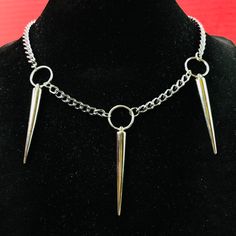 Punk Rock Triple Spikes Necklace Choker O Ring Necklace O-Ring Thorns Pendants On Silver Color Curb Chain Necklace Choker. Approximate Length 18” Width 5mm. Material: Steel Chain, Silver Or Stainless Steel Color Plated Alloy Spikes And Oring , Spikes Punk Length: 2” Spikes Are Hollow Light Weight O-Ring Diameter: 15mm Please Be Aware That The Items Have Spikes. Please Be Cautious And Be Careful In Using Them. By Purchasing The Items, You Are Aware And Take Your Own Risk Of Anything Involved In U Punk Gold Stainless Steel Jewelry, Punk Style Stainless Steel Jewelry For Party, Punk Stainless Steel Jewelry For Party, Edgy Adjustable Clavicle Chain Necklace, Punk Style Gold Jewelry For Streetwear, Punk Style Stainless Steel Party Jewelry, Punk Style Clavicle Chain For Festivals, Metal Choker With Adjustable Chain For Concerts, Rock Style Jewelry Choker For Alternative Fashion