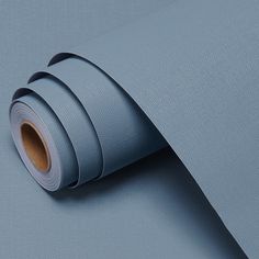 a roll of light blue colored paper on top of a table