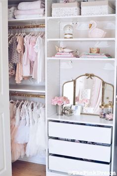 a white closet filled with lots of clothes