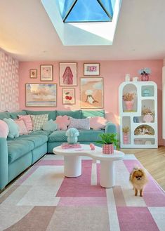 a living room with pink and blue furniture, pictures on the wall and a dog standing in front of it