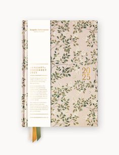 the front and back pages of a planner book with gold foil lettering on floral paper