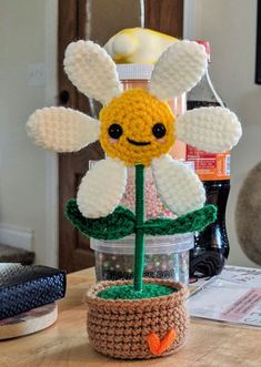 a crocheted flower sitting on top of a wooden table