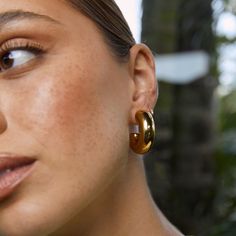 Meet the Bella Earrings, a stunning statement hoop here to add some drama to your outfit! These chunky golden hoops are truly flawless and are sure to elevate your look day or night.  Our styling tips: Pair Bella with a bold statement necklace like Isla for a stand out look. Crafted with precision, these earrings showcase a 14k gold plating (1 micron) over a stainless steel base. Finished with e-coating for added shine, they are both lead and nickel free, ensuring safe wear for all.   CARING FOR YOUR AOE JEWELS  At Arms Of Eve, we take great pride in the quality of all our jewels. All of our pieces are suitable for daily wear. Our jewels are 100% nickel and lead free. All our pieces are plated 1 microns thick in 14k Gold, as well as an e-coating for a premium finish.  In order for your jew K Drama Outfits, Gold Chunky Earrings, Thick Gold Hoop Earrings, Thick Gold Hoops, Chunky Gold Hoop Earrings, Bold Statement Necklaces, Golden Hoops, August Birthstone Jewelry, July Birthstone Jewelry