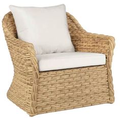 a wicker chair with white pillows on the back and seat cushion in front of it