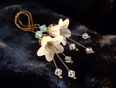 White bell flower earrings, also available in my shop in pink, purple, teal, dark blue with bead studded stamens dangling down from within. These romantic ANNALEAS FINEST earrings are created with Swarovski® crystals. Romantic elf fairy jewelry gift for women and garden lovers! Leverbacks keep them safely in your ears!  The other colors are shown in the additional photos. Click this link for more unique creations! https://www.etsy.com/shop/AnnaleasFinest?ref=seller-platform-mcnav Whimsical Dangle Earrings With Flower Charm, Whimsical Dangle Jewelry With Flower Charm, Whimsical Dangle Flower Earrings, White Flower Earrings, Elf Fairy, White Flower Earring, Terrarium Jewelry, Flower Dangle Earrings, Y2k Jewelry