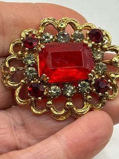 Central large faceted stone claw set smaller red crystal stones and white crystal stones fancy gold design with a roll over clasp Crystal Stones, Red Crystals, Vintage Brooch, White Crystal, Gold Design, Vintage Brooches, Stones And Crystals, Brooch Pin, Brooches