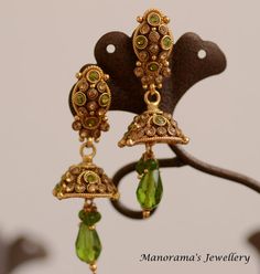 Athulya Dangle earrings - Studded with Parrot Green and Gold Zircon Crystals by ManoramasJewellery Green Crystal Metal Earrings, Green Crystal Pierced Earrings For Party, Green Metal Drop Clip-on Earrings, Green Teardrop Metal Earrings, Green Metal Clip-on Earrings For Gift, Gold Plated Green Jewelry With Latkans, Green Gold-plated Jewelry With Latkans, Traditional Green Brass Earrings, Green Metal Dangle Earrings