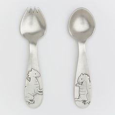 two spoons with animals on them and one has a fork in the shape of an animal