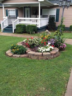 a flower bed in front of a house