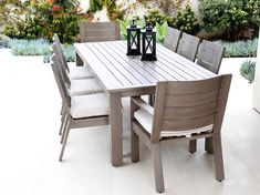 an outdoor table and chairs on a patio