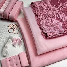 pink fabric and accessories laid out on a table