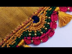 an embroidered piece with tassels and beads